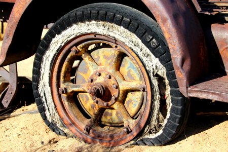 Brown Spoke Car Wheel In Brown Sand During Daytime photo