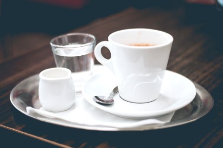 Coffee Cream And Water On Silver Tray photo