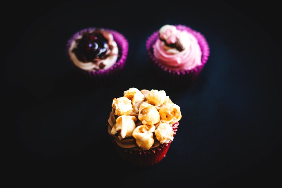 Yellow And Brown Cupcake Near Purple And White Cupcake