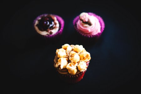 Yellow And Brown Cupcake Near Purple And White Cupcake
