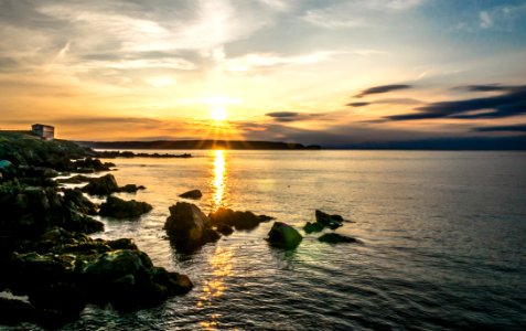 Sunset Over Rocky Ocean Coastline photo