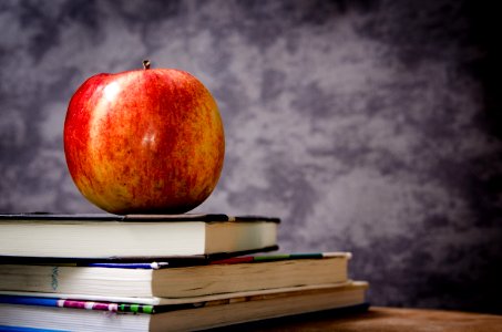 Red Apple On Black Book