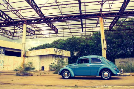 Blue Volkswagen Beetle In Front Of Building photo