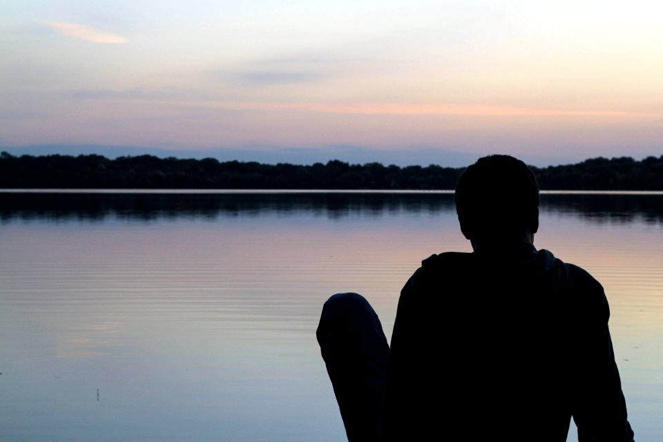 Man Resting Beside Lake