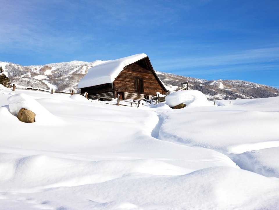 Heavy snow surrounds and lies a top a cabin in Steamboat Springs, Colorado. Original image from Carol M. Highsmith’s America, Library of Congress collection.