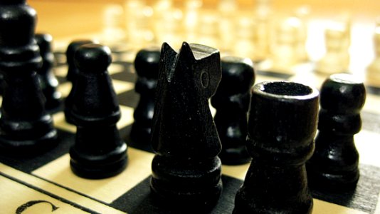 Black Chess Pieces On Chess Board photo