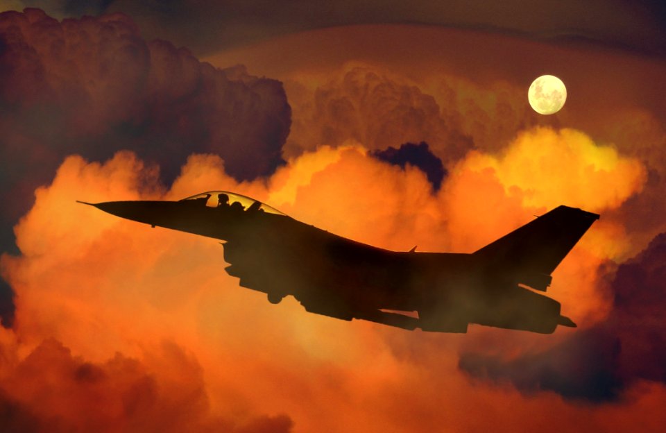 Silhouette Of Fighter Plane Flying Through Clouds