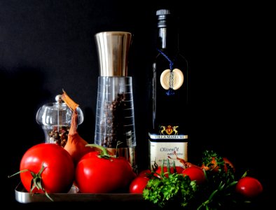 Tomatoes Beside Shakers And Olive Oil Bottle photo
