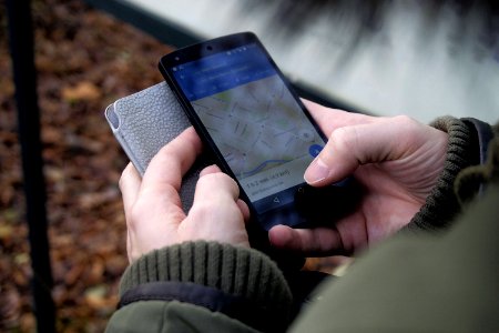 Person Looking At Map On Smartphone photo