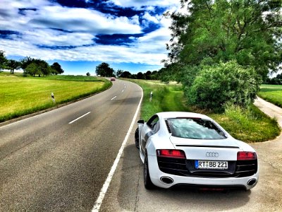 White Audi Coupe On Gray Concrete Road During Textile