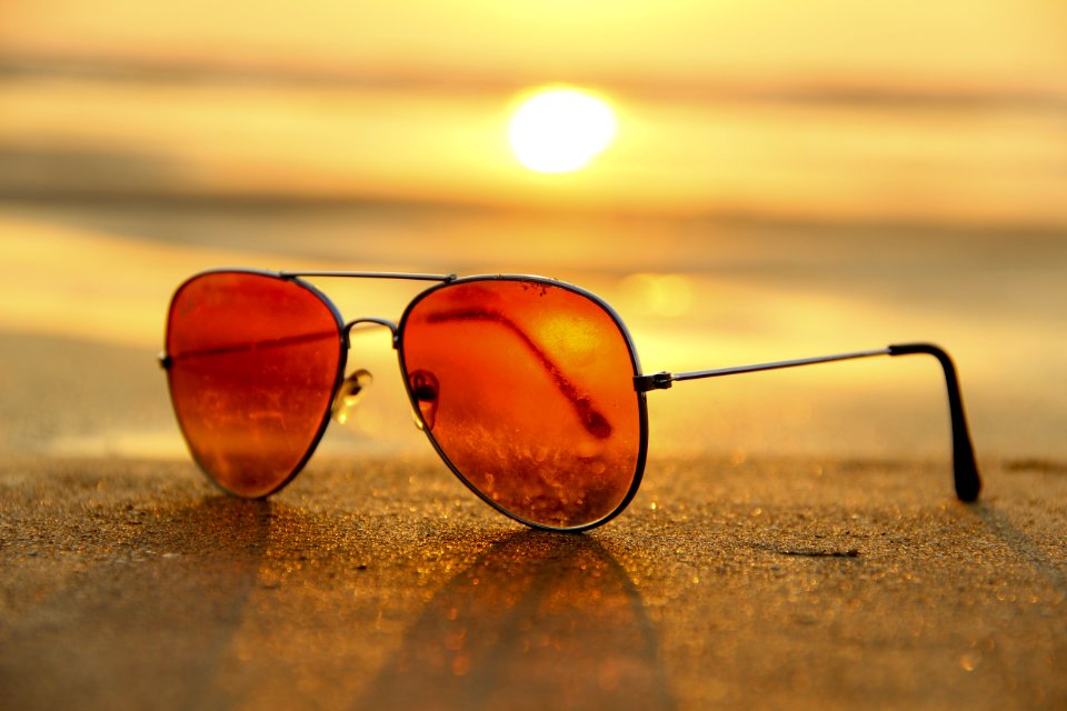 Sunglasses On Beach At Sunset photo