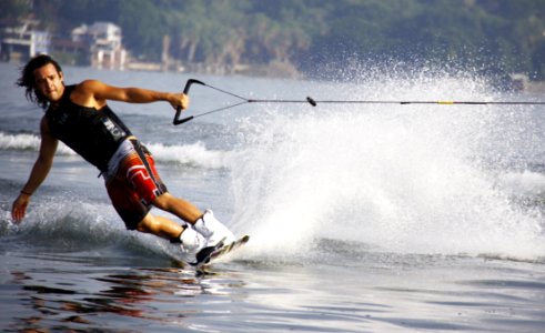 Man In Black Tank Top And Red Shorts Waveboarding photo