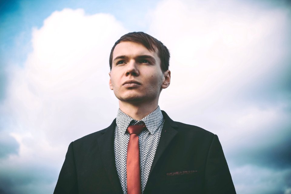 Portrait Of Young Man Against Sky