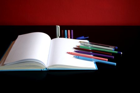 Blank Notebook Beside Color Pens