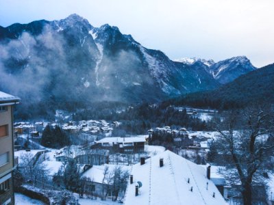 Snow Covered House Near Snow Covered Mountain Under Clear Sky photo