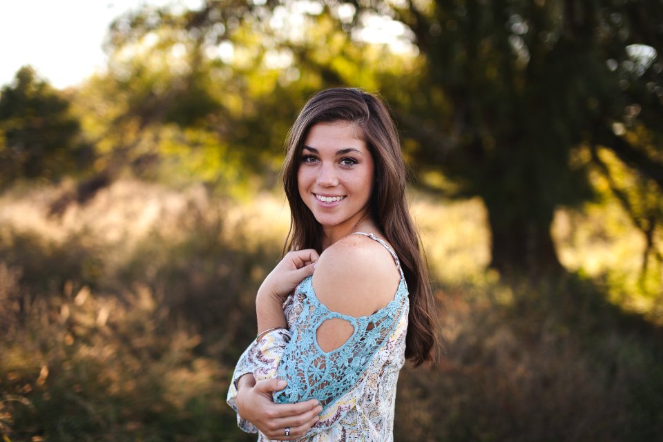 Woman In Blue White Cold Shoulder Shirt photo