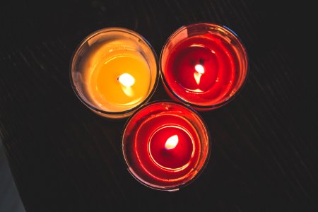 Lighted Red Wax Candle On Clear Drinking Glass photo
