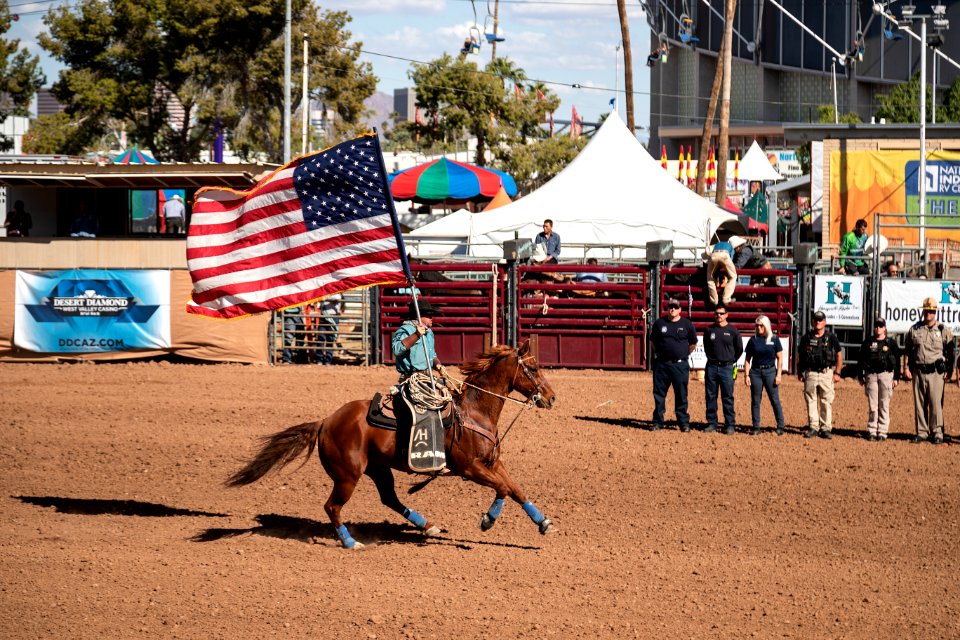 Flag bearer in Phoenix at the All-Indian Rodeo, a featured competition, open only to Native Americans with proof of tribal identification, at the annual Arizona State Fair, which has been held since 1884, eighteen years before statehood, when it was a territorial fair. Original image from Carol M. Highsmith’s America, Library of Congress collection.