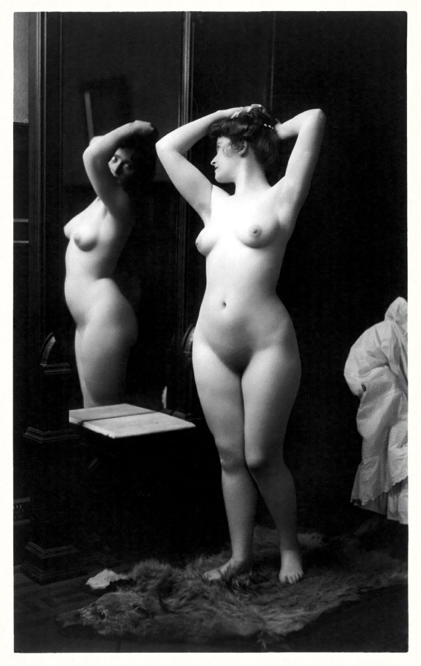 Young woman modeling: full length nude looking in mirror (1902) by Fitz W. Guerin.