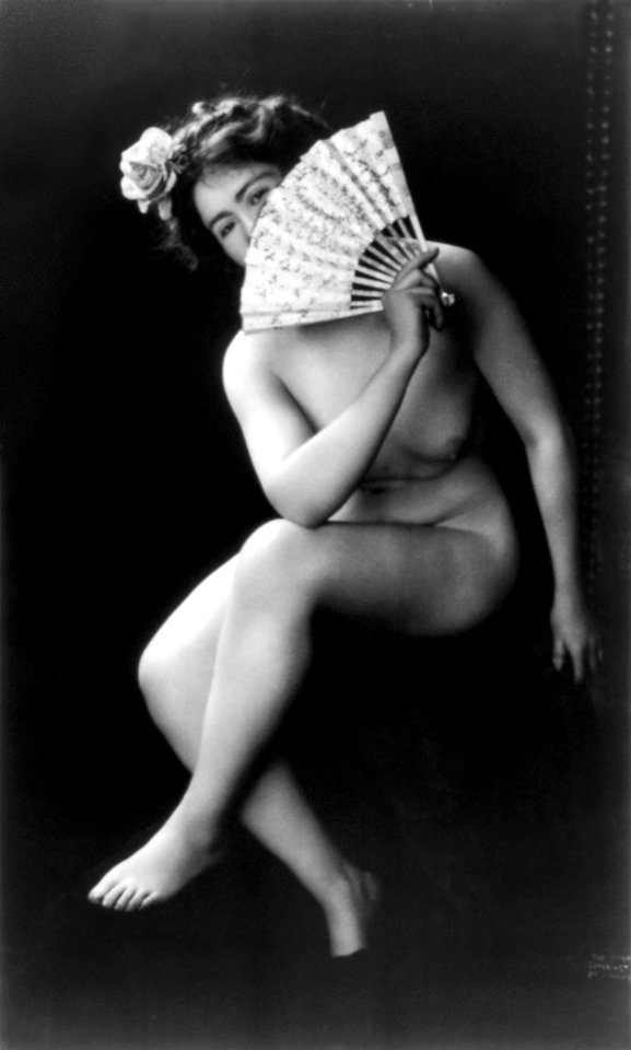 Nude woman with fan portrait photograph: The Coquette (ca. 1900) by J.M. Guerin.