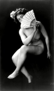Nude woman with fan portrait photograph: The Coquette (ca. 1900) by J.M. Guerin.