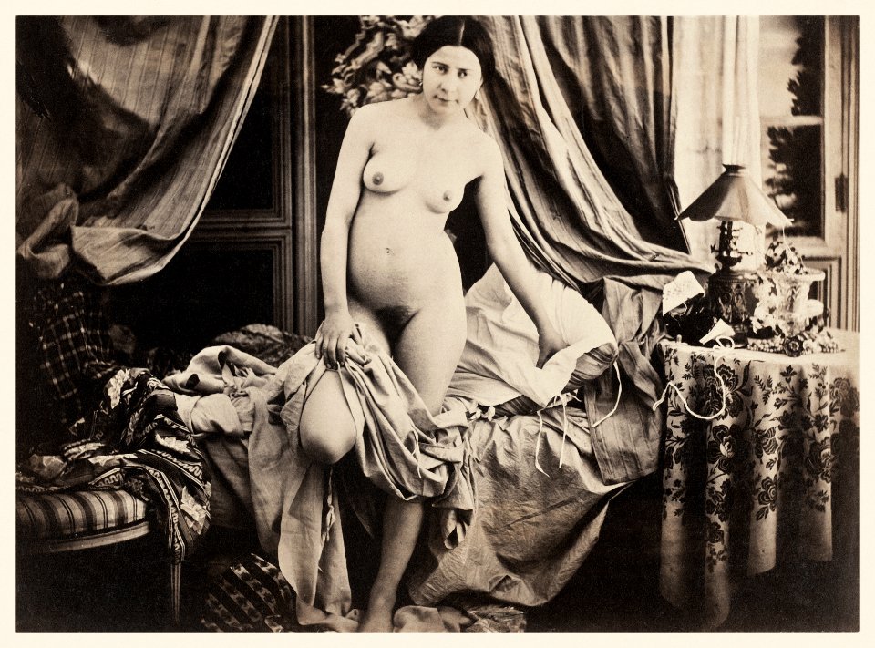 Nude photography of naked woman, Nude Standing by Bed (ca. 1854) by Auguste Belloc.