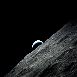 Crescent Earth rises above the lunar horizon taken during the Apollo 17 mission.