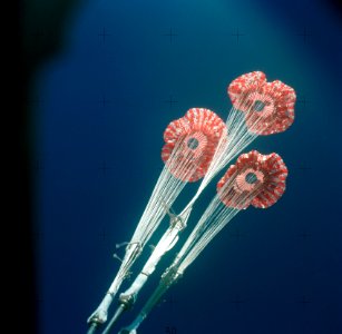 The three main ring sail parachutes of the Skylab 3 command module as they unfurl during descent to a successful splashdown in the Pacific Ocean. photo