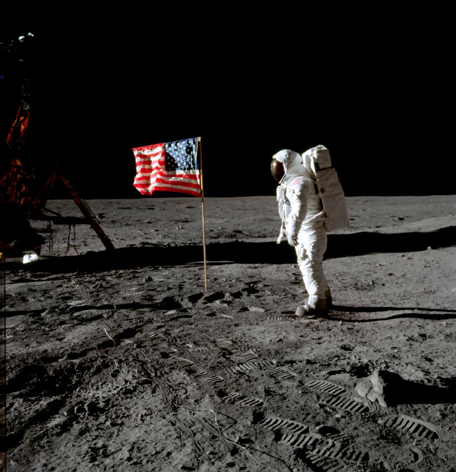 Astronaut Edwin E. Aldrin Jr., beside the deployed United States flag during an Apollo 11 extravehicular activity on the lunar surface.