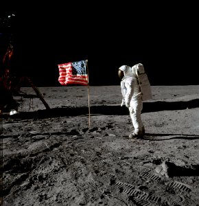 Astronaut Edwin E. Aldrin Jr., beside the deployed United States flag during an Apollo 11 extravehicular activity on the lunar surface.
