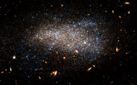Hubble Nets a Subtle Swarm. This Hubble image shows NGC 4789A, a dwarf irregular galaxy in the constellation of Coma Berenices. photo