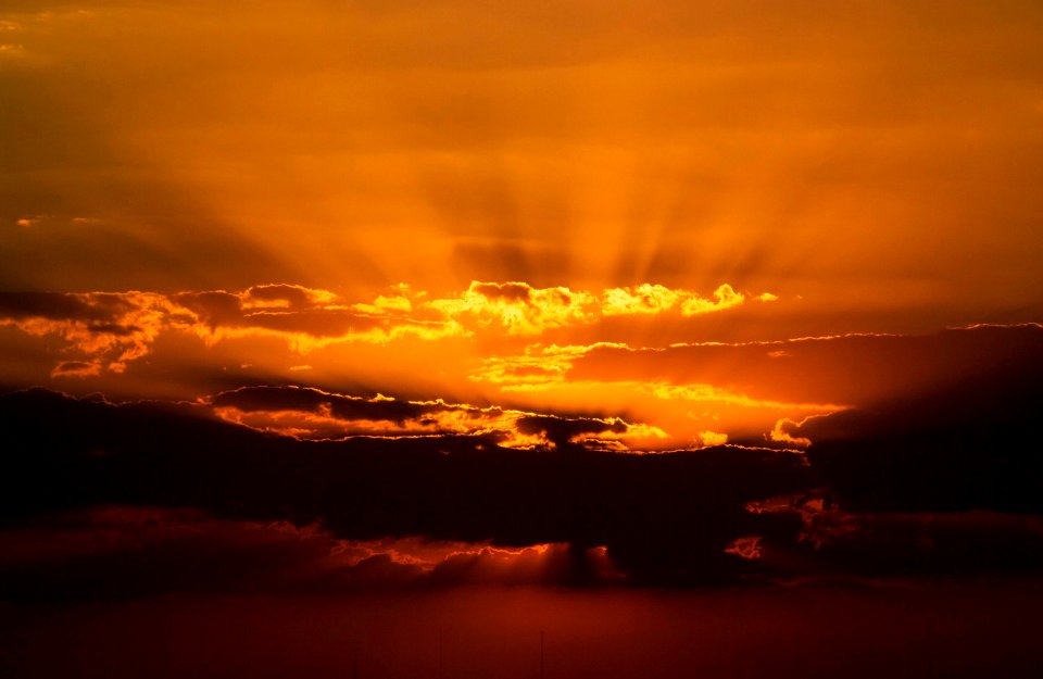 The setting sun paints the clouds over NASA's Kennedy Space Center in Florida.