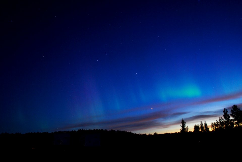 NASA's BARREL Mission in Sweden. The faint green glow of aurora can be seen above the clouds at Esrange Space Center in this photo from Aug. 23, 2016.