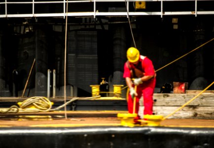 Workers control support ropes from the space shuttle Enterprise to lift it off of a barge and onto the Intrepid Sea, Air and Space Museum where it will be permanently displayed . photo