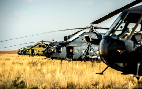 Russian search and rescue MI-8 helicopters are seen at the landing site of the Soyuz TMA-08M spacecraft in a remote area near the town of Zhezkazgan, Kazakhstan. photo