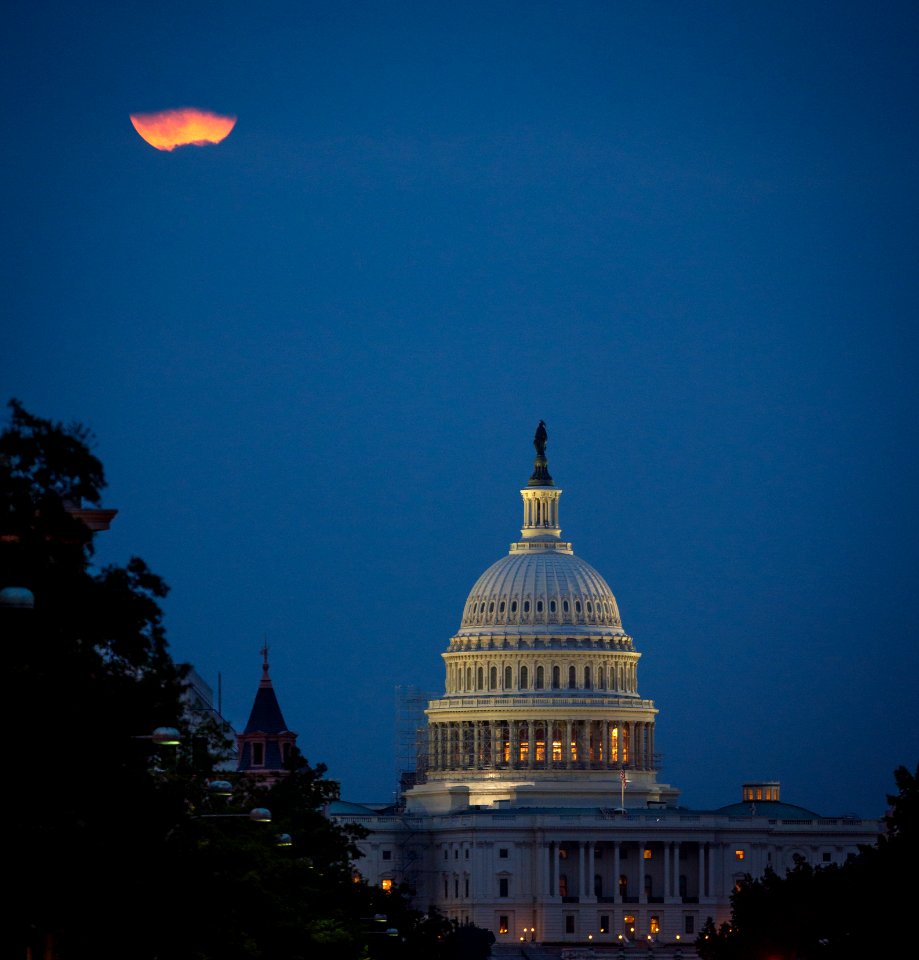 A perigee full moon or supermoon is seen behind clouds over the United States Capitol, Sunday, August 10, 2014, in Washington.