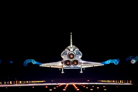 Vapor trails follow space shuttle Atlantis as it approaches Runway 15 on the Shuttle Landing Facility at NASA's Kennedy Space Center in Florida for the final time. photo
