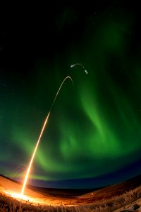 Sounding rocket launches successfully from Alaska and a green aurora dancing over Alaska. All four stages of the rocket are visible in this image. Jan. 28th, 2015.