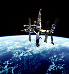 Russia's Mir space station is backdropped against Earth's horizon.