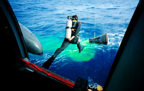 A Navy frogman leaps from a recovery helicopter into the water to assist in the Gemini-12 recovery operations.