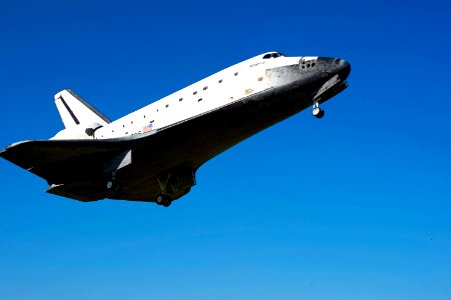 Coming in from the southeast, space shuttle Atlantis belly is visible in a crystal-clear blue sky as it approaches Runway 33 at the Shuttle Landing Facility at NASA's Kennedy Space Center in Florida. photo