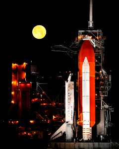 A nearly full Moon sets as the space shuttle Discovery sits atop Launch pad 39A at the Kennedy Space Center in Cape Canaveral, Florida, Wednesday, March 11, 2009. photo