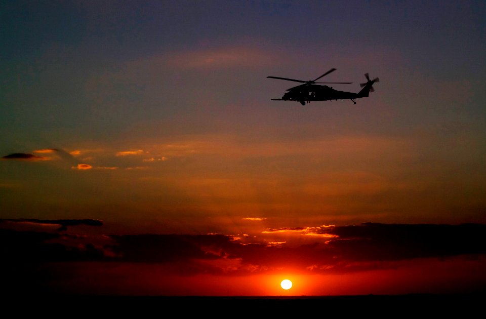 A helicopter patrols the sky over NASA's Kennedy Space Center in Florida before the launch of space shuttle Discovery on the STS-119 mission.