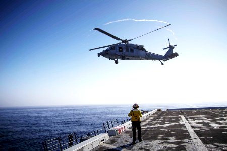 An H60-S helicopter takes off from the deck of the USS Anchorage during the first day of Orion Underway Recovery Test 3 activities in the Pacific Ocean. photo