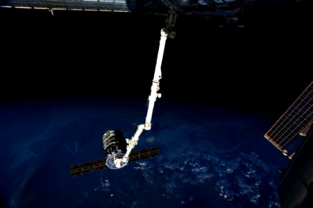 The International Space Station’s Canadarm2 prepares to release the Orbital Sciences' Cygnus commercial cargo craft after a month visiting the orbital outpost. photo