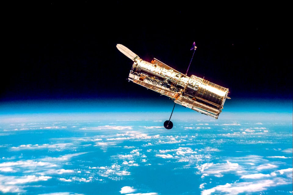The Hubble Space Telescope hovers at the boundary of Earth and space.