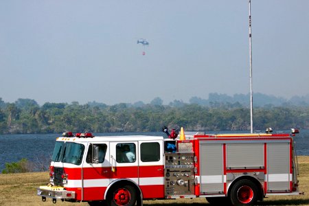 At NASA's Kennedy Space Center in Florida, a helicopter collects water from the Turn Basin to douse a nearby brush fire, 27 April 2011. photo
