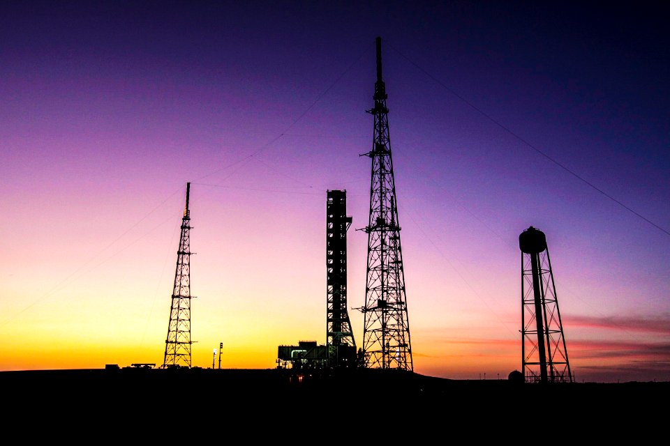 With the sun setting in the background at NASA’s Kennedy Space Center in Florida, the mobile launcher is nearing completion of its 4.2-mile journey to Launch Pad 39B.