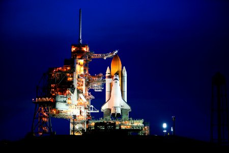 Space shuttle Atlantis, attached to its bright-orange external fuel tank and twin solid rocket boosters on Launch Pad 39A at NASA's Kennedy Space Center in Florida.