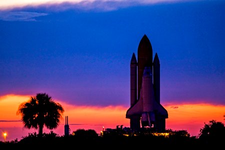 Space shuttle Discovery is silhouetted against the dawn sky as it rolls out to Launch Pad 39A at NASA's Kennedy Space Center in Florida.
